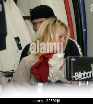 Exclusive!! Pamela Anderson and her husband Rick Salomon go Christmas shopping for the kids at a surfing store near Anderson's home. The actress was still without a wedding ring and was dressed down in a baggy dress and no make-up. The couple also stopped by the Malibu Country Mart to pick up some take-out food. Malibu, CA. 12/16/07.     [[rac ral]] Stock Photo