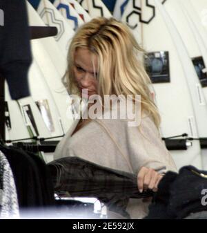 Exclusive!! Pamela Anderson and her husband Rick Salomon go Christmas shopping for the kids at a surfing store near Anderson's home. The actress was still without a wedding ring and was dressed down in a baggy dress and no make-up. The couple also stopped by the Malibu Country Mart to pick up some take-out food. Malibu, CA. 12/16/07.     [[rac ral]] Stock Photo