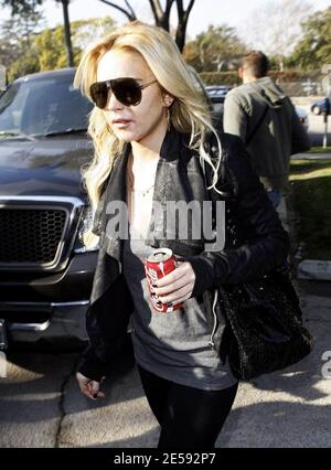 Lindsay Lohan was spotted with Coke today! Coca Cola that is! The actress was snapped leaving the Italian restaurant La Scala holding a can of full-sugar Coca Cola. Beverly Hills, CA. 12/17/07.   [[mll]] Stock Photo