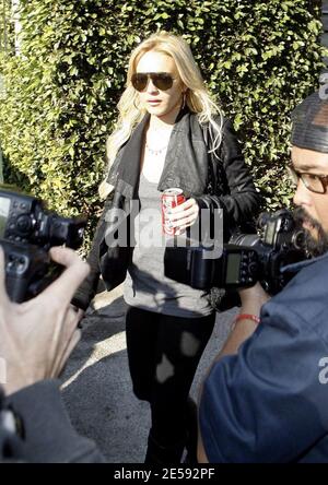 Lindsay Lohan was spotted with Coke today! Coca Cola that is! The actress was snapped leaving the Italian restaurant La Scala holding a can of full-sugar Coca Cola. Beverly Hills, CA. 12/17/07.   [[mll]] Stock Photo