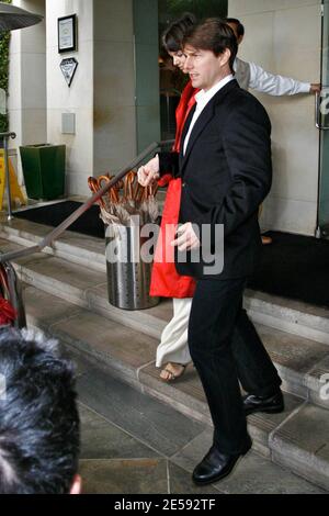 Tom Cruise and Katie Holmes make their way out of the Raffles L