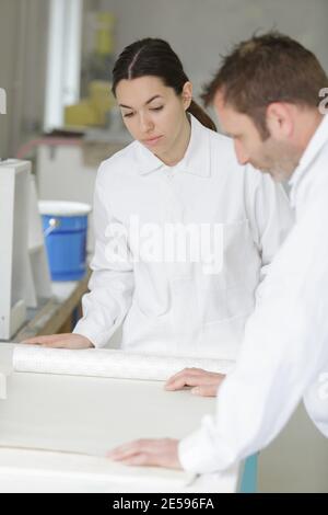 the painter is working with an apprentice Stock Photo