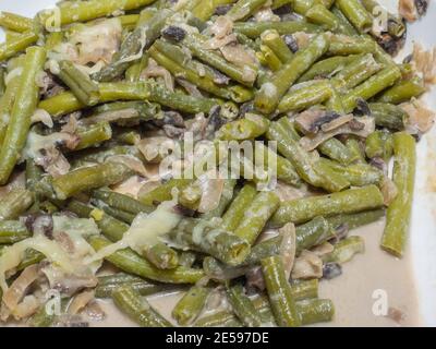 Green bean casserole is a casserole consisting of green beans, cream of mushroom soup, and french fried onions. It is a popular Thanksgiving side dish Stock Photo