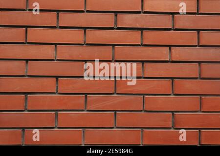 The texture of an old brick wall with natural defects. Scratches, cracks, crevices, chips, dust, roughness, abrasion. Template for design and backgrou Stock Photo