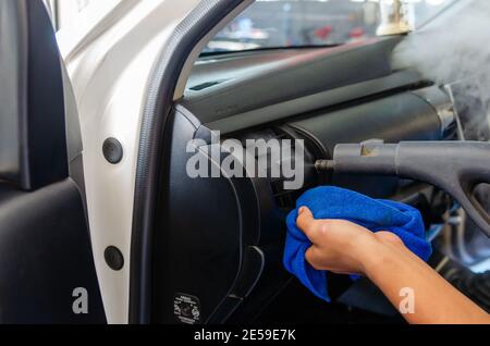 Steam cleaning in the car's air vents. Use high heat steam to kill germs to clean at the car service. Stock Photo