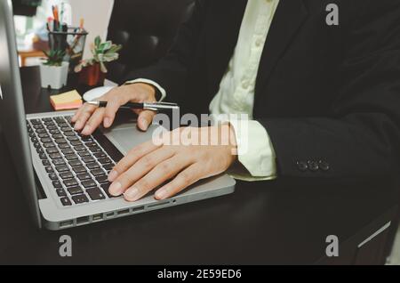 Businessman seacrh find information on Internet social media with computer laptop on desk. work for home. Stock Photo