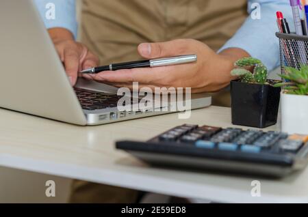 Business men are using computers to find information, the Internet, social network or online businesses work from home. Stock Photo
