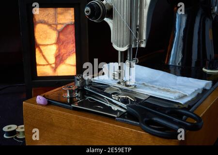 Sewing machine and parts on a dark background Stock Photo