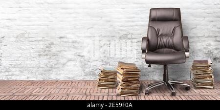 an employee's chair and a stack of documents on   white brick wall  background with copy space .Concept Stock Photo