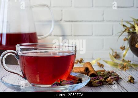 Glasses of linden, pomegranate flowers, green tea, grape seeds, olive leaves, cinnamon sticks and dried rose. Selected focus front glasses. Stock Photo