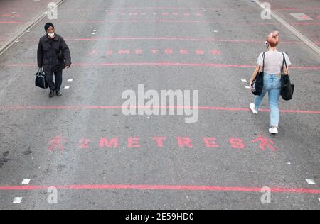 File photo dated 17/06/2020 of people walking over two metre social distancing markings at Ridley Road street market in east London, whilst the government considered relaxing official guidelines on social distancing to a shorter distance of one metre. Saturday January 30 marks the one year anniversary of the earliest known death from coronavirus in UK. Issue date: Wednesday January 27, 2021. Stock Photo