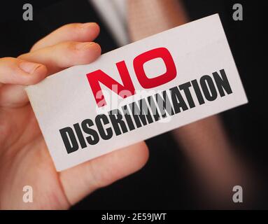 No discrimination words on a card in businessman hand. Social concept against racial and gender discrimination at work Stock Photo