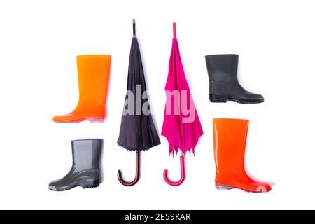 Rubber shoes and umbrella for couple isolated on white background. Rain season and weather forecast. Nobody Stock Photo