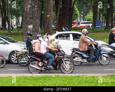 Motorbikes with many people in the traffic in District 1, Ho Chi Minh City, Vietnam. Stock Photo