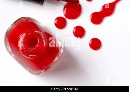 Bright colored nail polish bottles with drippings on white background Stock Photo