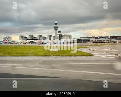 Ready for takeoff on a bad weather rainy day. Looking out aircraft window to Schiphol airport. Stock Photo