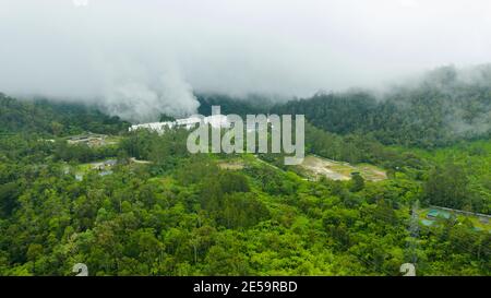 Geotermal power plant on Mount Apo. Geothermal station with steam and pipes in the rainforest. Mindanao, Philippines. Stock Photo