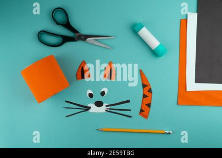 Step 5. Step-by-step instructions on how to make a stand for stationery from a tin can. Tiger made of paper and cardboard, scissors and glue. A fun DI Stock Photo