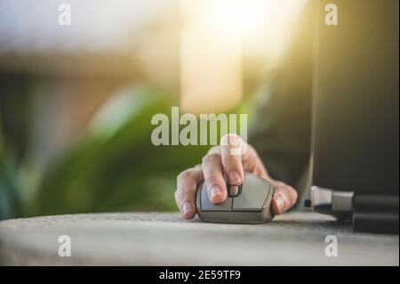 Hand use mouse laptop computer Stock Photo