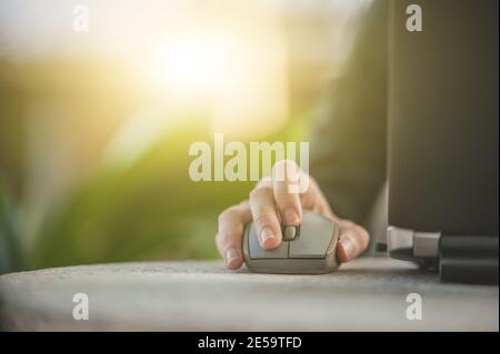 Hand use mouse laptop computer Stock Photo