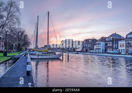 Gouda, The Netherlands, January 22, 2021: colorful sky at sunset over Kattensingel canal Stock Photo