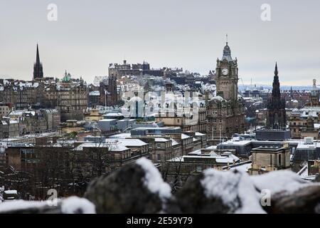 City view from Calton hill, looking at the Balmoral hotel and Edinburgh Castle, Scotland, During the winter, snow and icy conditions of 2021. Stock Photo