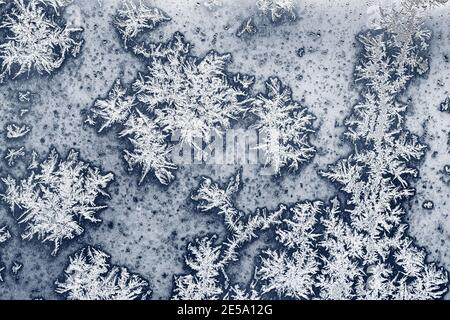 natural background - hoarfrost on blue window pane close up on cold winter day Stock Photo