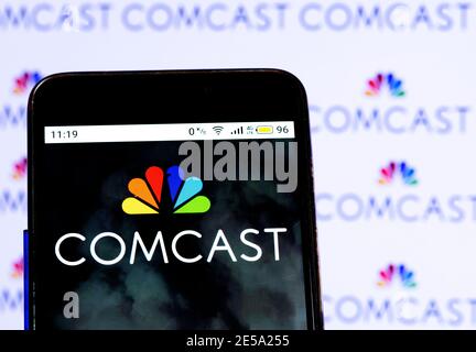 In this photo illustration a Comcast logo seen displayed on smart phone Stock Photo