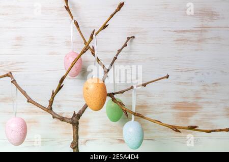 Easter decorative eggs hanging on branches in spring. Colorful Easter mood background. Easter time concept. Copy space. Stock Photo