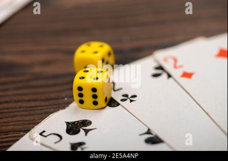 Playing cards and dice on a wooden table. Close-up, selective focus. Stock Photo