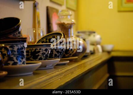 Teacups and saucers on a mantle Stock Photo