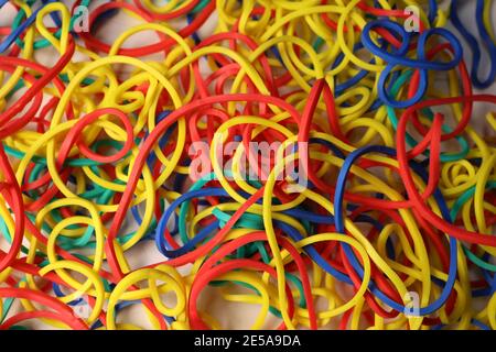 Multi-colored elastic band rubber scattered on the table. Stock Photo