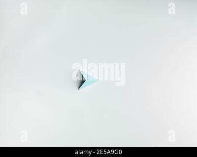 blue paper pyramid , on white background copy space available. Stock Photo
