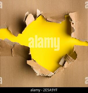 Yellow paper with brown torn ripped paper Stock Photo
