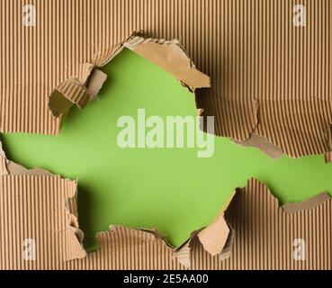Green paper with brown torn ripped paper Stock Photo