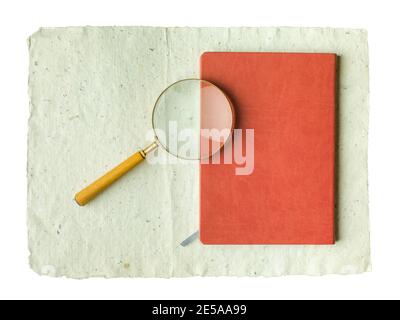 Recycled cream, grey vintage horizontal note paper texture. Vintage magnifier on top of a notebook. Stock Photo