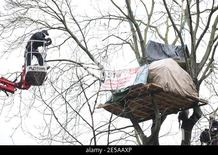 A cherry picker approaches an HS2 Rebellion treetop camp in an encampment in Euston Square Gardens in central London, where the protesters have built a 100ft tunnel network, which they are ready to occupy, after claiming the garden is at risk from the HS2 line development. Picture date: Wednesday January 27, 2021. Stock Photo