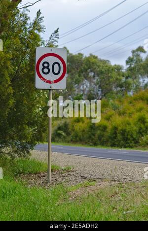 Australian's 80 km per hour speed limit sign on side of road Stock Photo