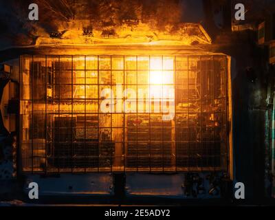 Glowing modern glass greenhouse in winter night, top view. Stock Photo