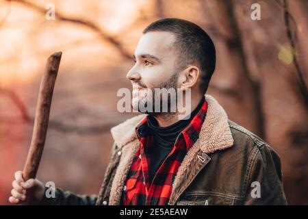Young man looking at the sunrise on a mountain top. Stock Photo