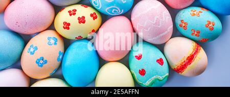 Colorful Easter hunting eggs dyed by colored water with beautiful pattern on pastel blue background, design concept of holiday. Stock Photo