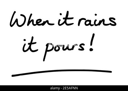 When it rains it pours! handwritten on a white background. Stock Photo