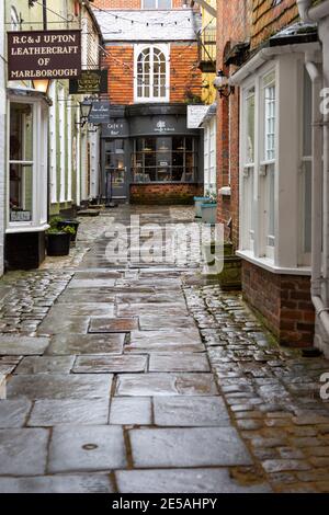 Shops in Old Hughenden Yard alleyway wet  weather no people, Marlborough, Wiltshire, England, UK Stock Photo