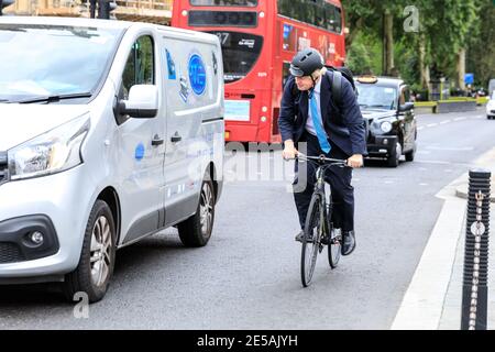Boris Johnson MP, British Conservative Party politician, riding his bicycle at Parliament in Westminster, London, UK Stock Photo