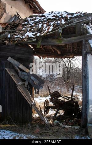 Old falling down barn in a village house in the mountains of Bulgaria Stock Photo