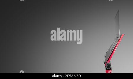 Open slim and modern laptop computer at a red stand isolated at gradient grey background with copy space, details, closeup Stock Photo