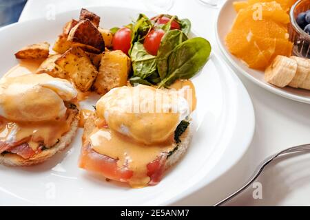 Eggs benedict with spinach, salmon and hollandaise sauce Stock Photo