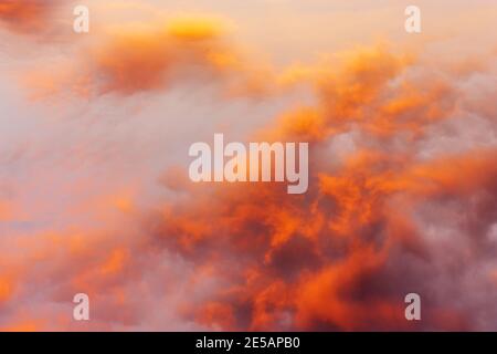 Sky and clouds in bright rainbow colors and smooth red colored sky in twilight - Perfect image as a background.  Stock Photo