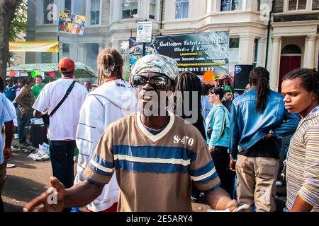 Guy with a bandana dancing in the street at Notting Hill Carnival Stock Photo