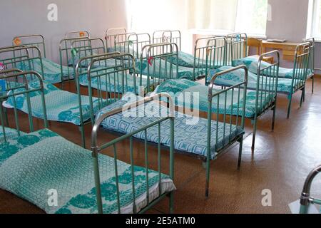 Interior of an old Russian kindergarten with iron beds. Stock Photo
